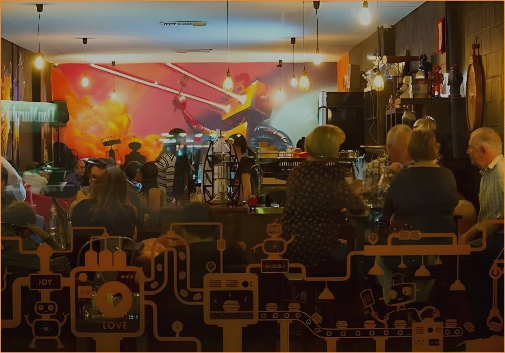 Robot Bun Factory cafe interior with customers, window artwork and robot wall mural celebrating the cafe history