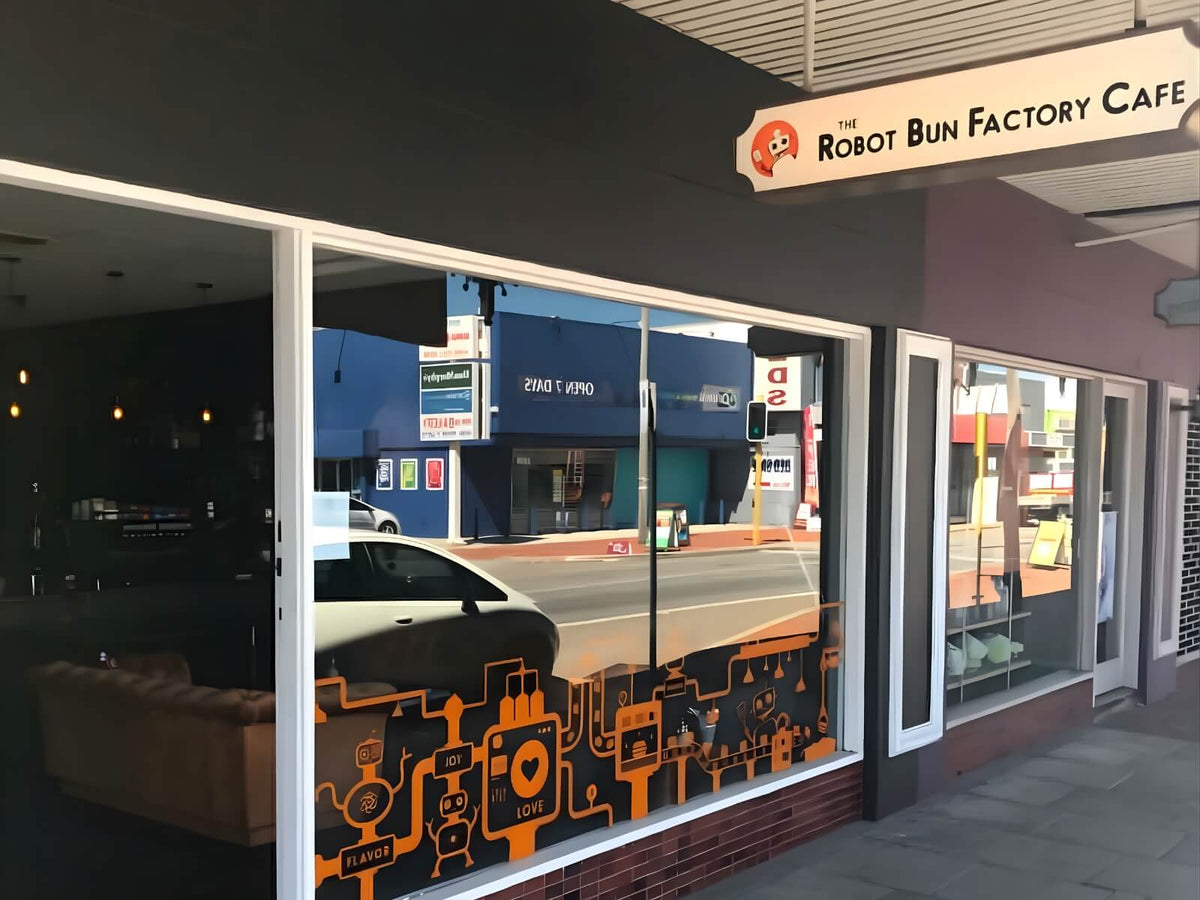 Robot Bun Factory Cafe storefront with window artwork and exterior signage