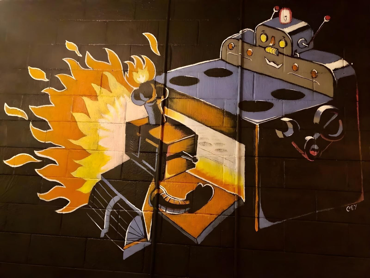Colourful robot wall mural with flames inside The Robot Bun Factory Cafe
