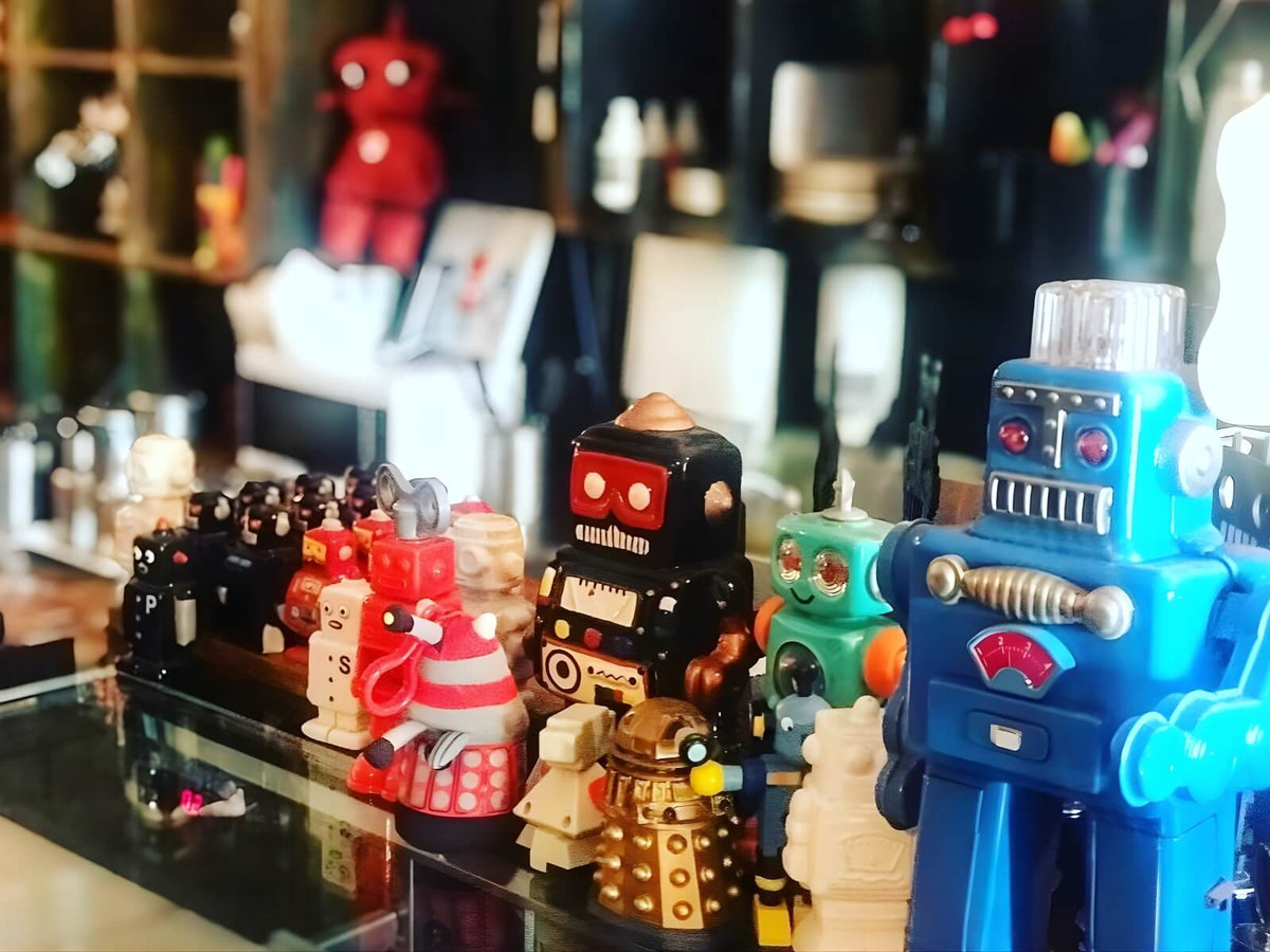Collection of colourful vintage robot toys displayed inside The Robot Bun Factory Cafe
