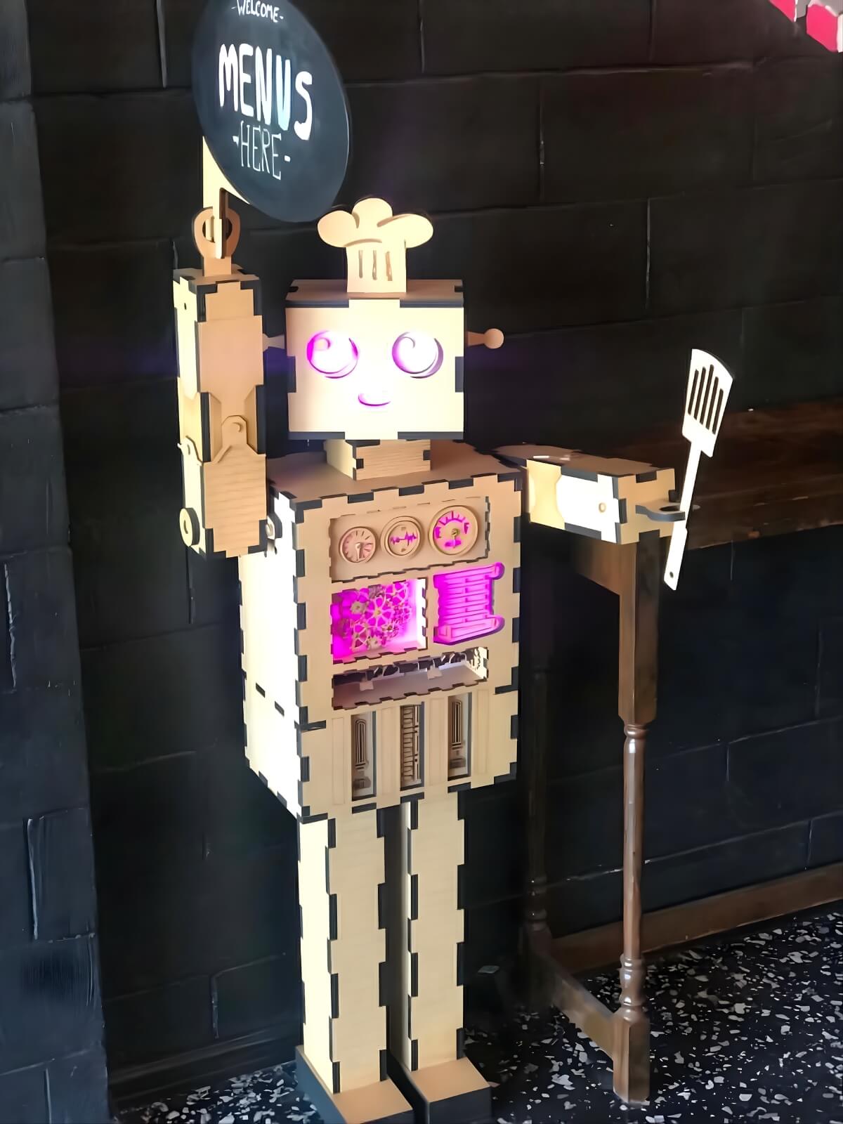 Wooden robot display inside Robot Bun Factory cafe with glowing details and menu sign