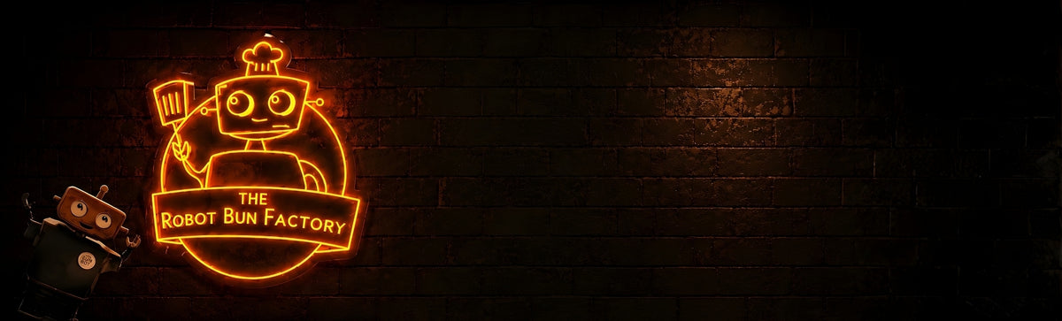 The Robot Bun Factory neon cafe sign on a dark brick wall with robot mascot, desktop homepage hero image